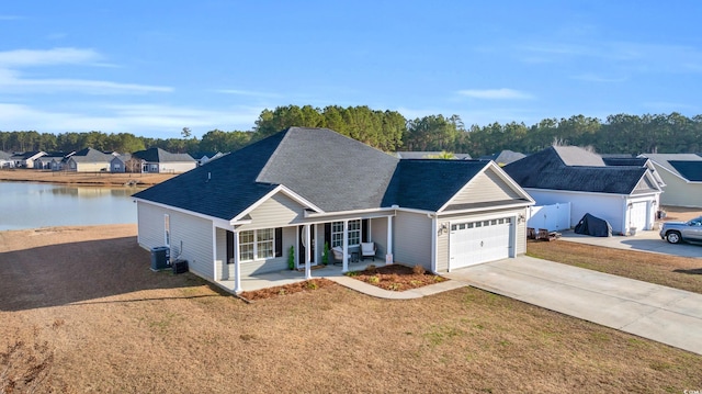 single story home with central air condition unit, covered porch, concrete driveway, a front yard, and a garage