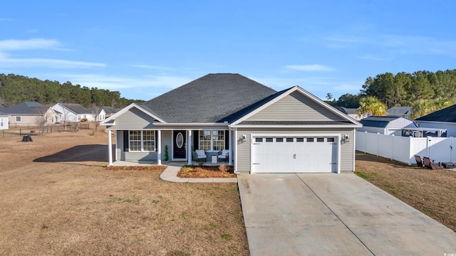 view of front of house featuring fence, driveway, a porch, a front lawn, and a garage