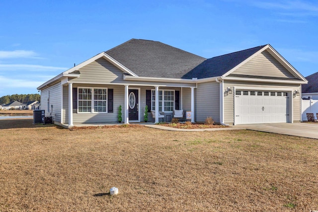 ranch-style house featuring central AC, driveway, an attached garage, and a front lawn