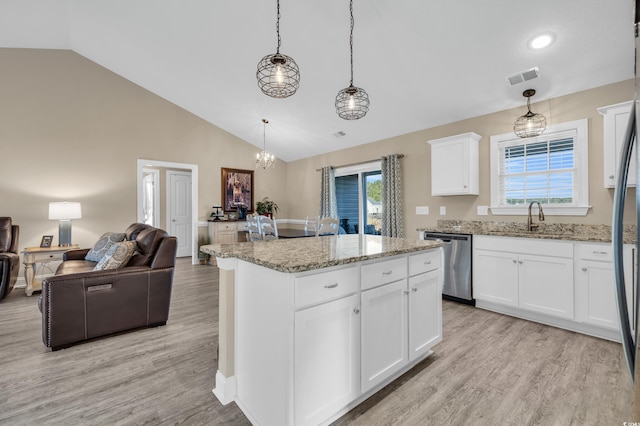 kitchen with dishwasher, light wood-style flooring, visible vents, and open floor plan