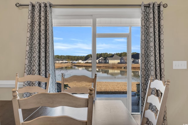 dining room featuring a water view and plenty of natural light