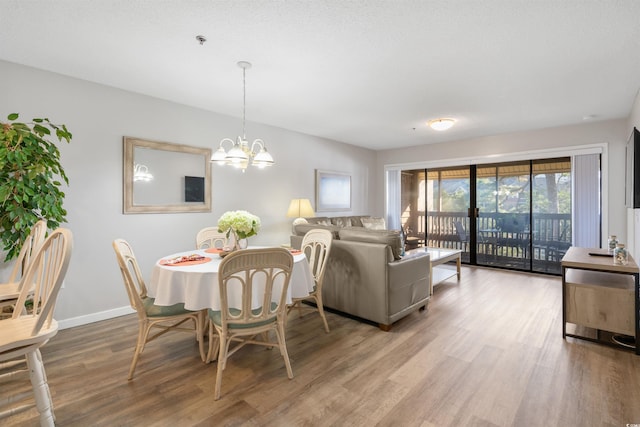 108 Rothbury Cir Unit 207, Myrtle Beach, SC 29572 - dining space featuring wood finished floors, a chandelier, and baseboards