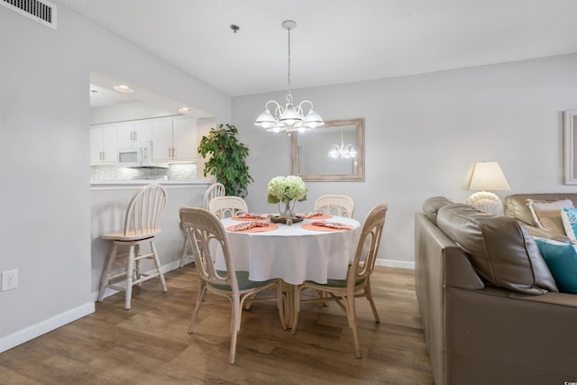 108 Rothbury Cir Unit 207, Myrtle Beach, SC 29572 - dining area with wood finished floors, a chandelier, baseboards, and recessed lighting