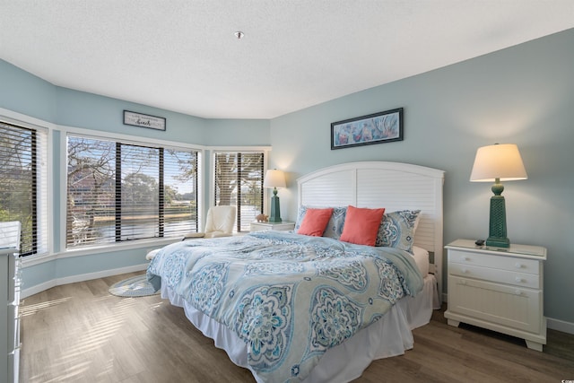 108 Rothbury Cir Unit 207, Myrtle Beach, SC 29572 - bedroom with baseboards, a textured ceiling, and wood finished floors