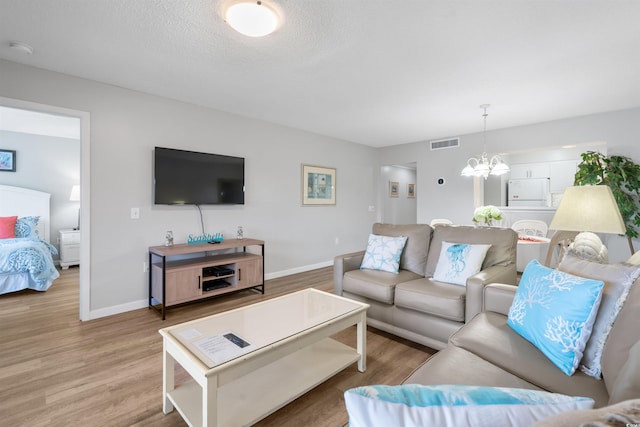 108 Rothbury Cir Unit 207, Myrtle Beach, SC 29572 - living area with a chandelier, light wood-type flooring, and baseboards