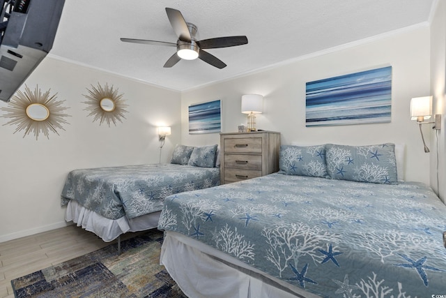 bedroom featuring crown molding, dark wood-type flooring, ceiling fan, and a textured ceiling