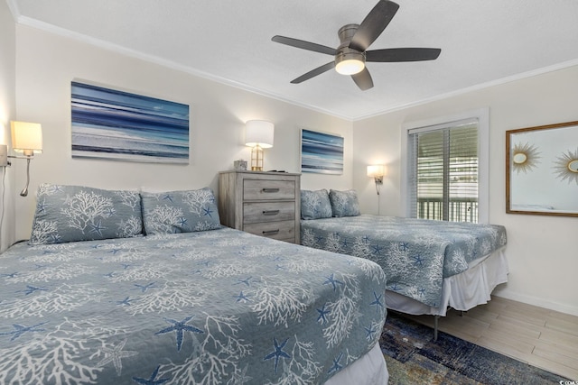 bedroom with ceiling fan, ornamental molding, and access to exterior