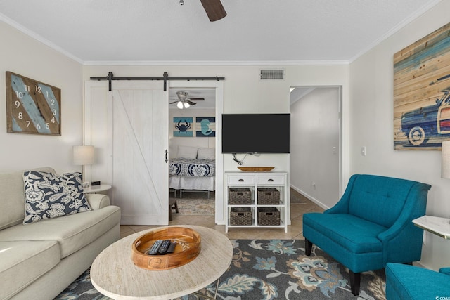 living room with ornamental molding, tile patterned floors, and ceiling fan