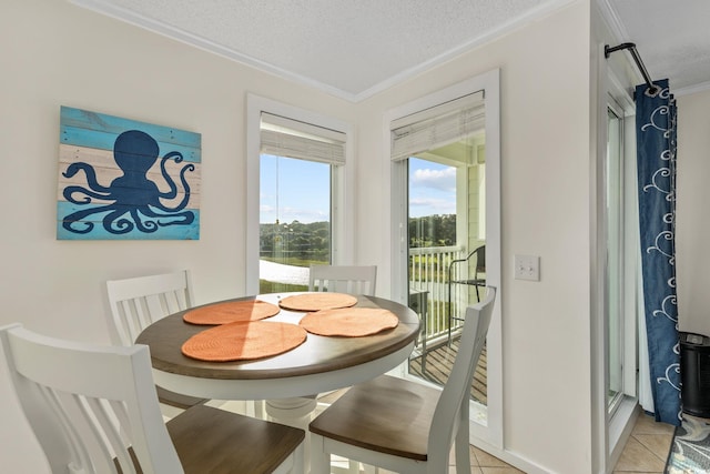 tiled dining space featuring crown molding and a textured ceiling