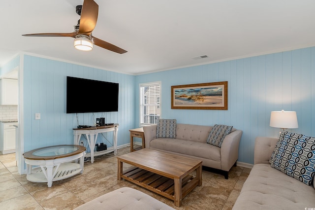 living room with crown molding and ceiling fan