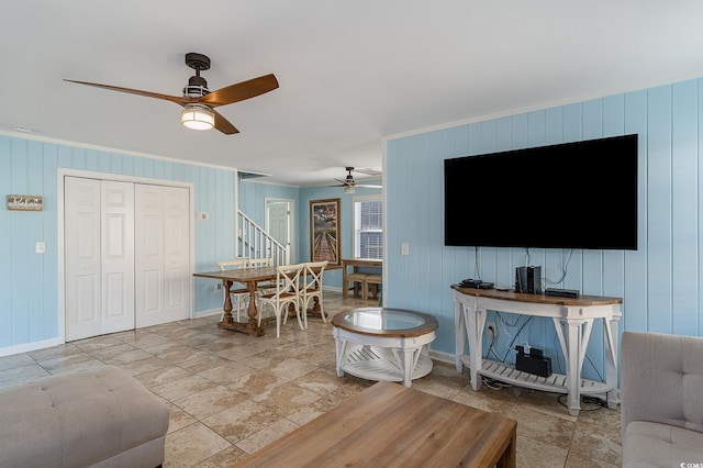 living room with crown molding and ceiling fan