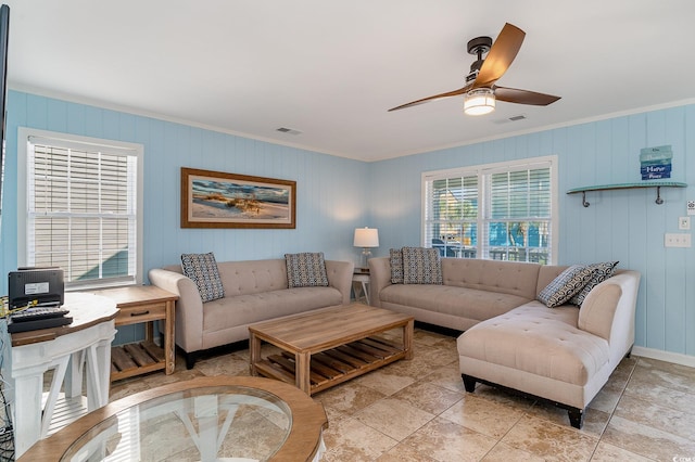 living room featuring ceiling fan and ornamental molding