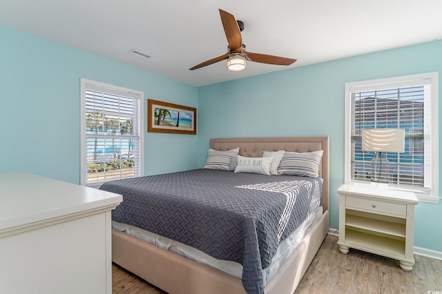 bedroom with ceiling fan and light wood-type flooring