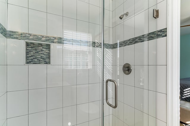 bathroom featuring a shower with door