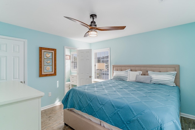 bedroom featuring hardwood / wood-style flooring, connected bathroom, and ceiling fan