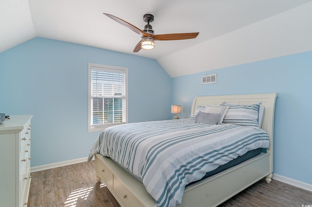 bedroom with vaulted ceiling, wood-type flooring, and ceiling fan