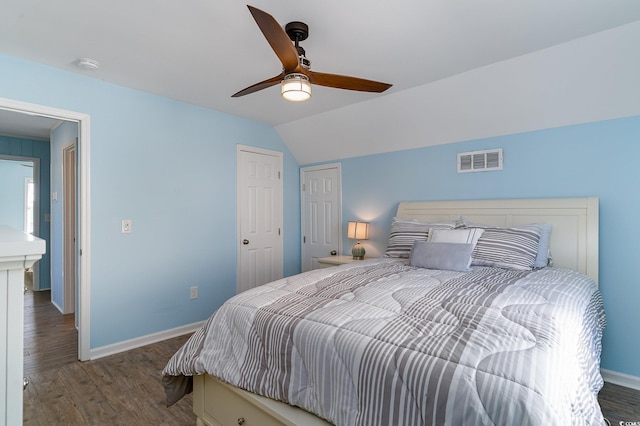 bedroom with dark hardwood / wood-style flooring, lofted ceiling, and ceiling fan