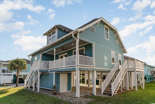 rear view of property featuring a yard, a patio area, and ceiling fan