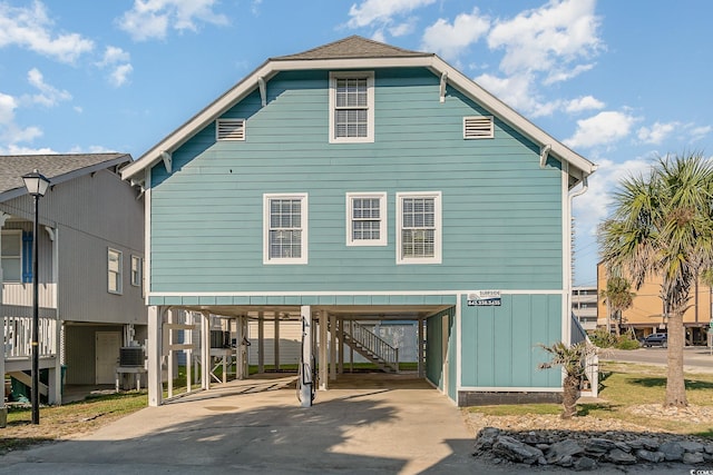 rear view of property with a carport