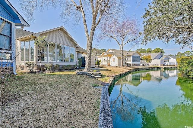 exterior space with a water view and a yard