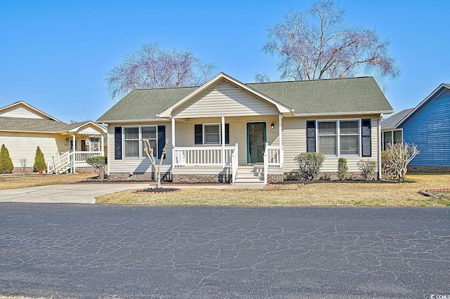 ranch-style home with covered porch and a front lawn