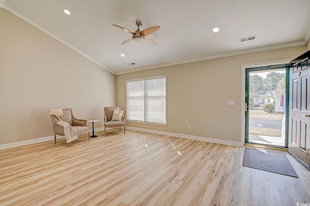 sitting room featuring ornamental molding, vaulted ceiling, ceiling fan, and light hardwood / wood-style flooring