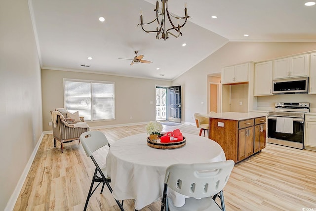 kitchen with lofted ceiling, white cabinetry, light wood-type flooring, a kitchen island, and stainless steel appliances