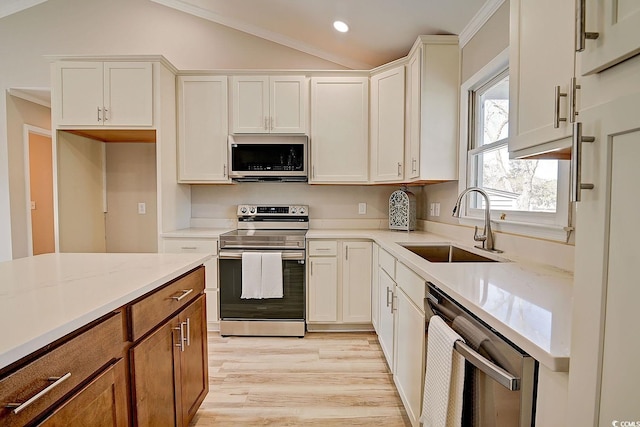 kitchen with appliances with stainless steel finishes, sink, and white cabinets