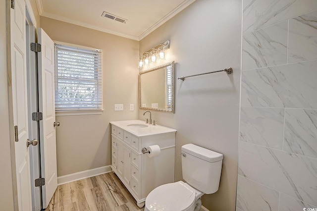 bathroom featuring ornamental molding, hardwood / wood-style floors, vanity, and toilet