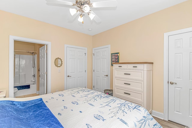 bedroom featuring ceiling fan, ensuite bathroom, and light hardwood / wood-style floors