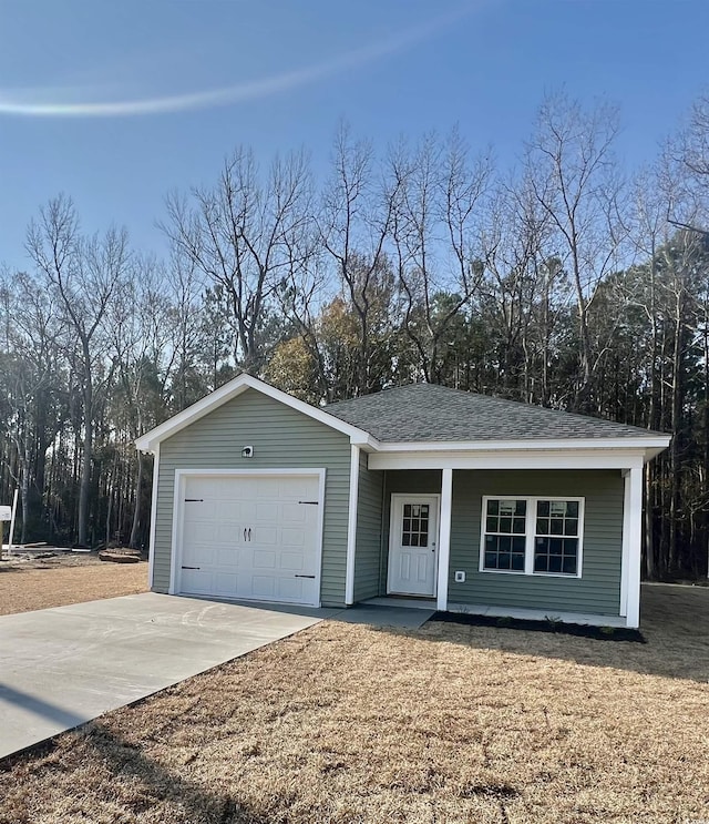 single story home featuring driveway, a shingled roof, and a garage