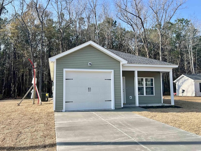 garage with central air condition unit and driveway