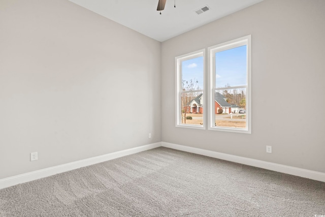 carpeted spare room with ceiling fan