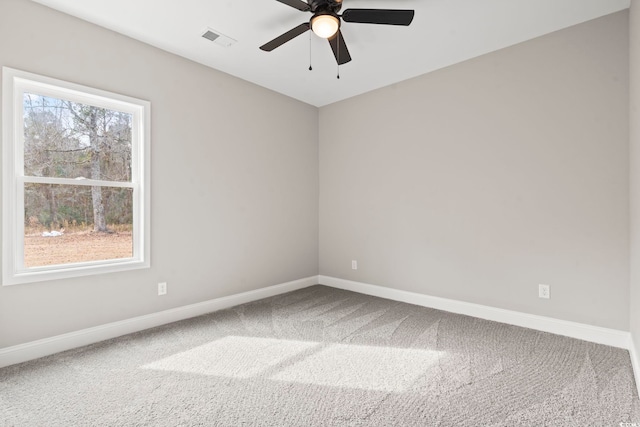 empty room with a healthy amount of sunlight, ceiling fan, and carpet flooring