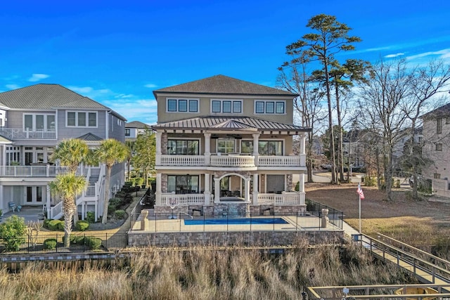 back of house with a balcony and a patio