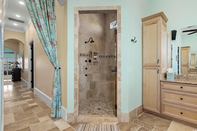 bathroom featuring walk in shower, ornamental molding, and vanity