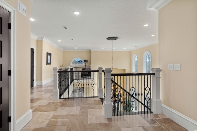 hallway featuring crown molding and a textured ceiling