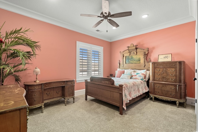 carpeted bedroom with ornamental molding and ceiling fan