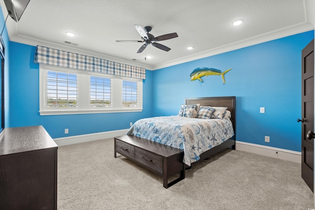 bedroom featuring ornamental molding, light carpet, and a textured ceiling