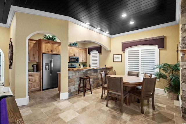 dining area with wood ceiling and crown molding