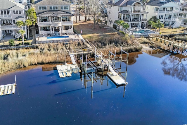 view of dock featuring a water view and a swimming pool