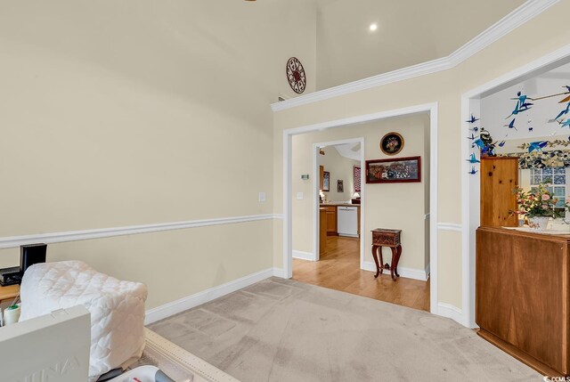 sitting room with crown molding and light colored carpet