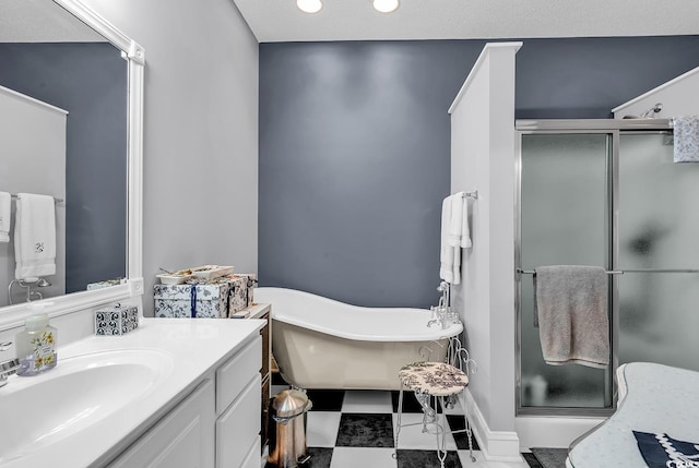 bathroom featuring a soaking tub, a shower stall, and vanity