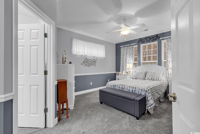 carpeted bedroom with a textured ceiling, baseboards, visible vents, and crown molding