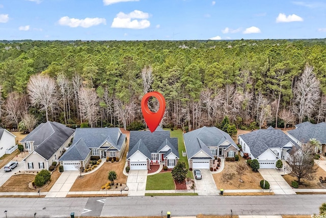 bird's eye view with a residential view and a wooded view