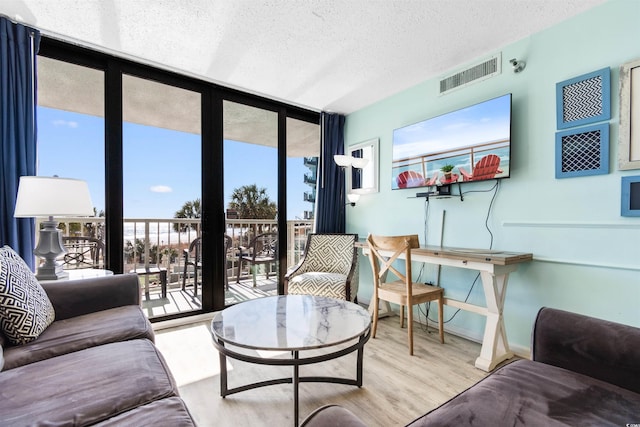 2700 N Ocean Blvd Unit 253, Myrtle Beach, SC 29577 - living room with a textured ceiling, wood finished floors, healthy amount of natural light, and baseboards