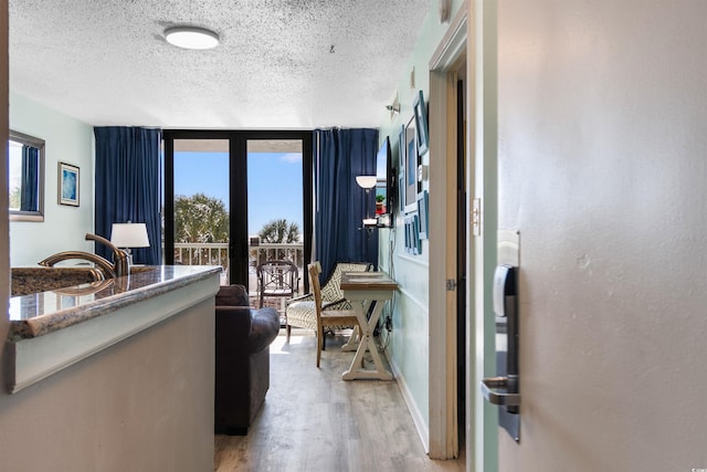 2700 N Ocean Blvd Unit 253, Myrtle Beach, SC 29577 - hall featuring a textured ceiling, light wood finished floors, and baseboards