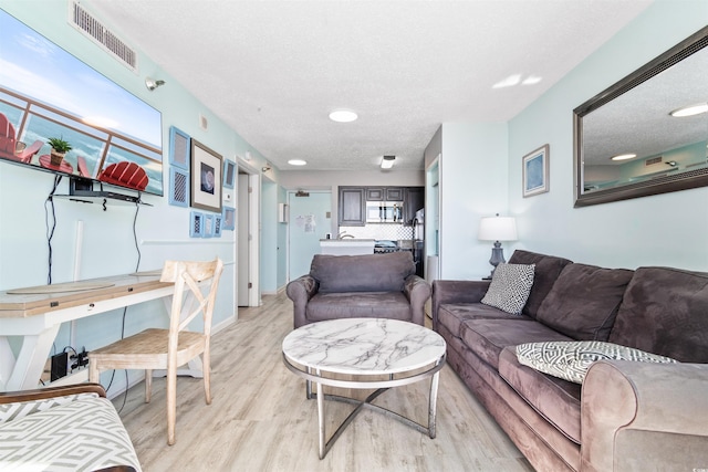2700 N Ocean Blvd Unit 253, Myrtle Beach, SC 29577 - living area with light wood finished floors and a textured ceiling