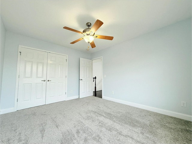 unfurnished bedroom with ceiling fan, carpet floors, baseboards, and a closet