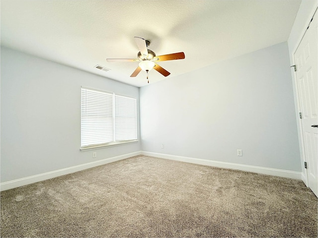 spare room featuring carpet and ceiling fan